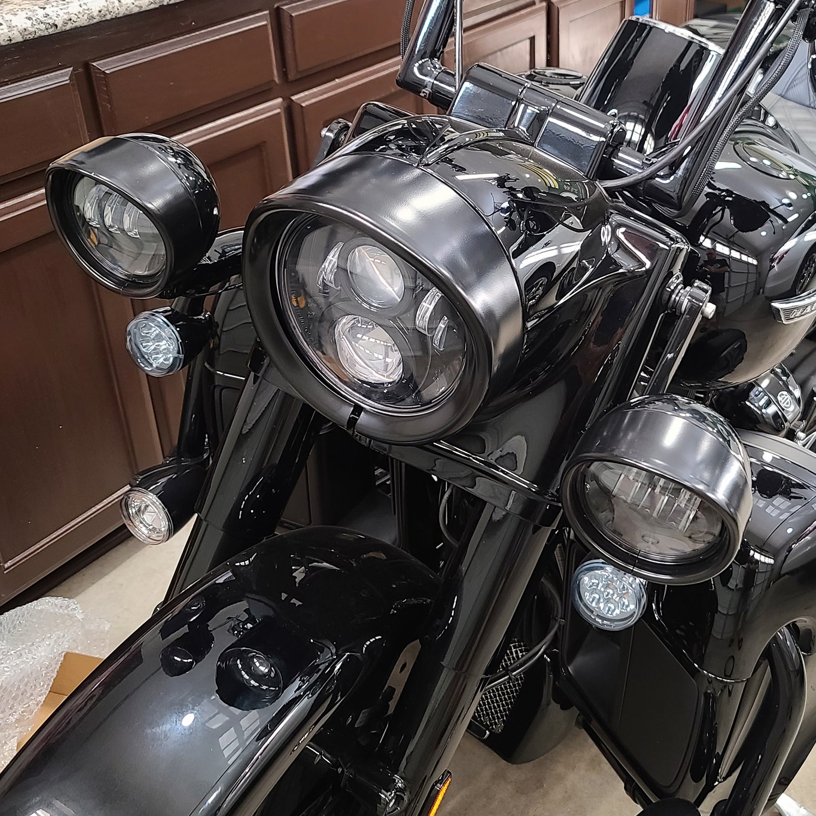 4.5" Auxiliary Passing Light Trim Ring Bezel for Harley-Davidson Touring Models (2PCS) installed on a motorcycle.